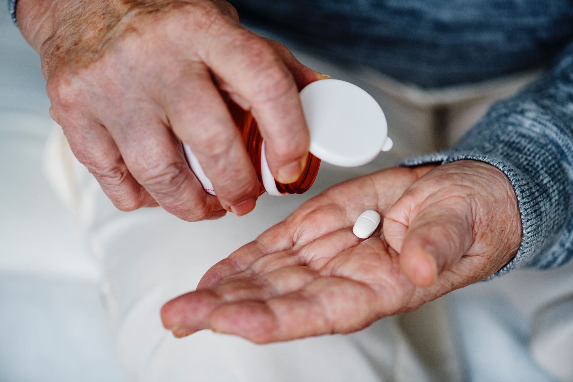 a close up of a hand with a pill