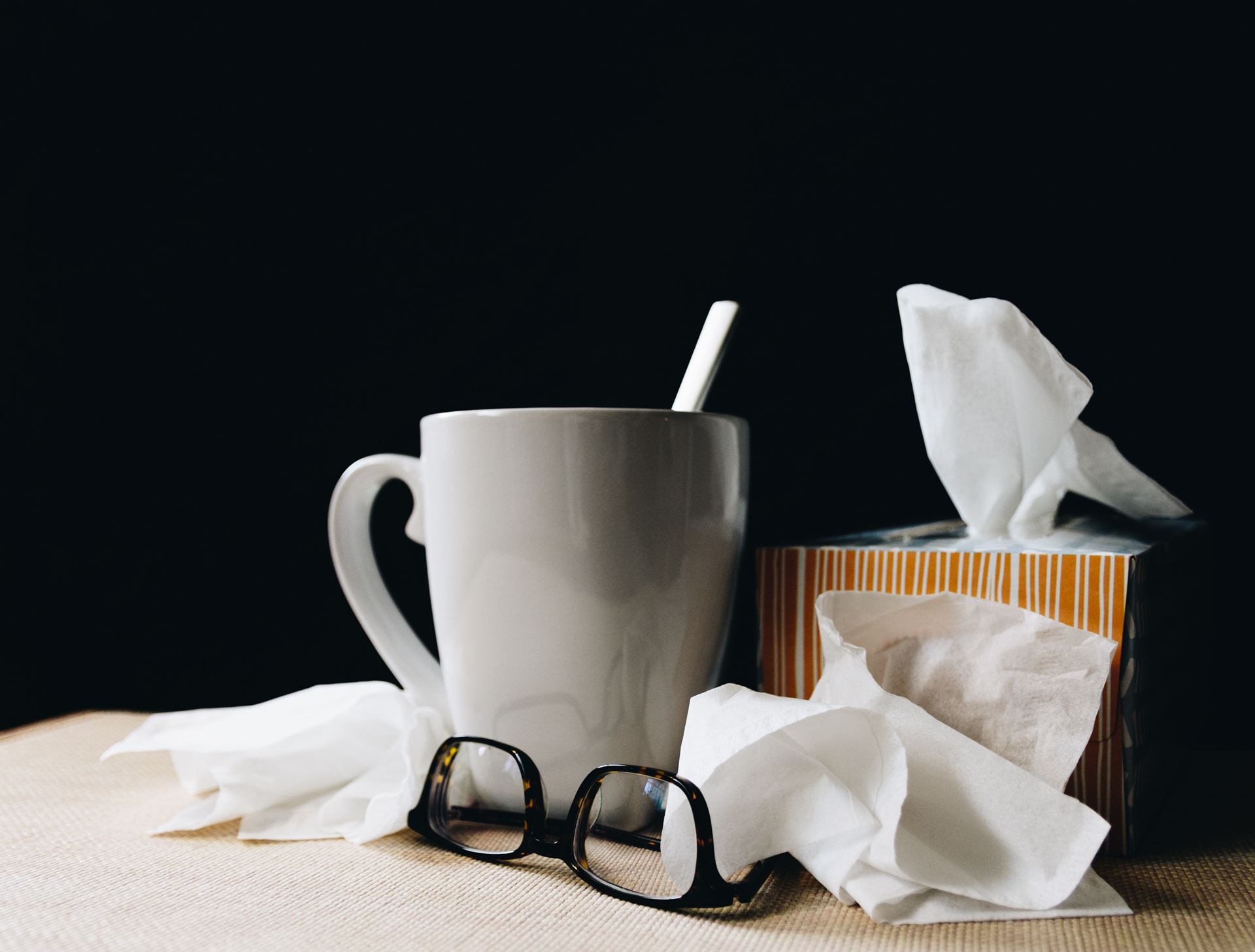 a cup and tissues on a table